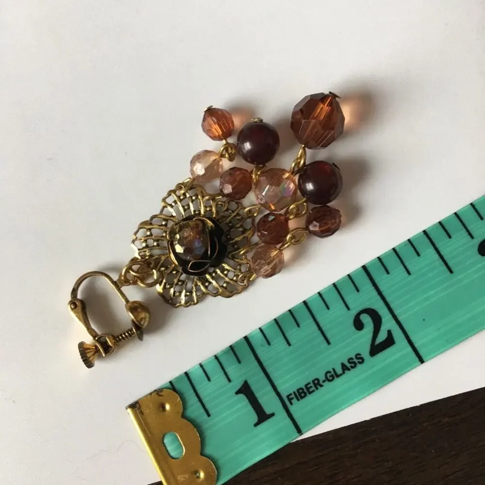 Darling ornate clip on earrings with beaded accents in amber/garnet tones